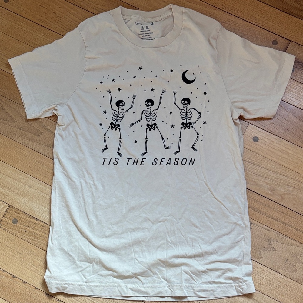 Celebrate It Cream Graphic Tee with Black Skeleton Design
